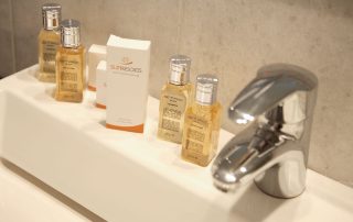 569789d7cca2fda82af671da-large Antinea Hotel - Junior Suite With Indoor Jacuzzi - Bathroom Sink with Travel Size Shampoos & Bath Foams