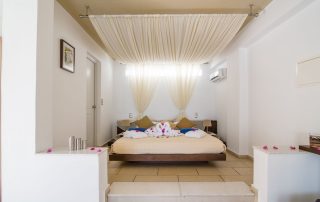 58ac34b7ba941bb41a2d147a-large Antinea Hotel - Junior Suite With Private Pool - Bed with Canopy decorated with swan towels and flowers